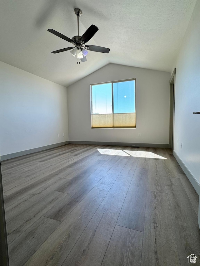 1126 E Bench View Dr N, Ogden, UT 84404 - unfurnished room featuring lofted ceiling, a ceiling fan, baseboards, and wood finished floors
