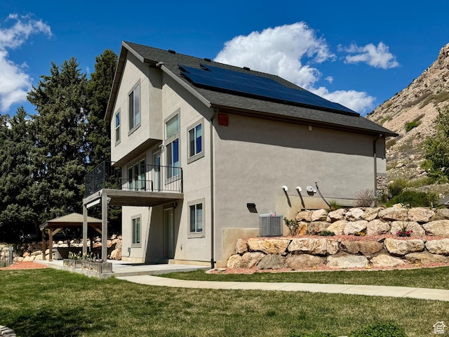 1126 E Bench View Dr N, Ogden, UT 84404 - exterior space with a gazebo, a lawn, roof mounted solar panels, a patio, and stucco siding