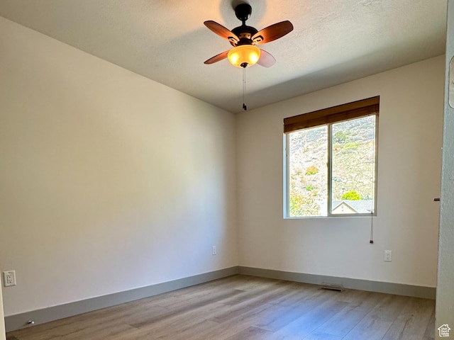 1126 E Bench View Dr N, Ogden, UT 84404 - spare room featuring light wood-type flooring, baseboards, a textured ceiling, and ceiling fan