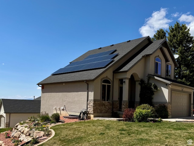 1126 E Bench View Dr N, Ogden, UT 84404 - view of side of home with stone siding, an attached garage, a yard, roof mounted solar panels, and stucco siding