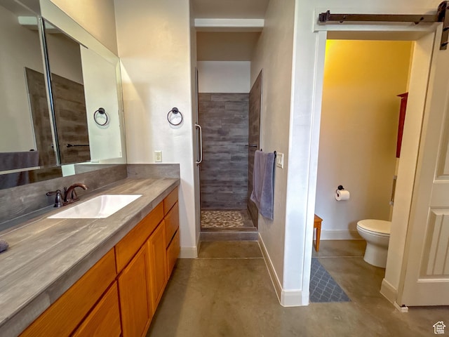 bathroom featuring a shower stall, toilet, vanity, and baseboards