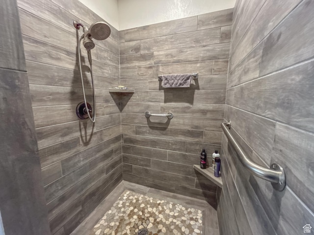 bathroom with tiled shower