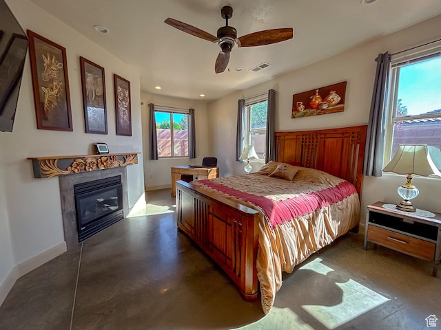 bedroom featuring baseboards, a glass covered fireplace, visible vents, and recessed lighting