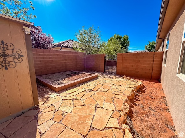 view of patio / terrace featuring a gate and fence