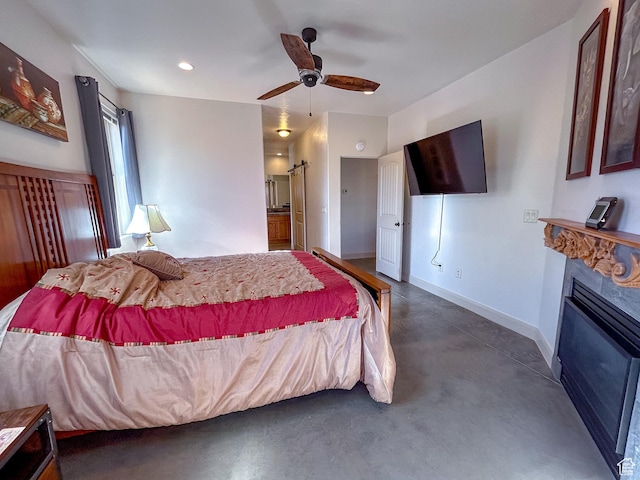 bedroom featuring baseboards, a glass covered fireplace, recessed lighting, finished concrete flooring, and a ceiling fan