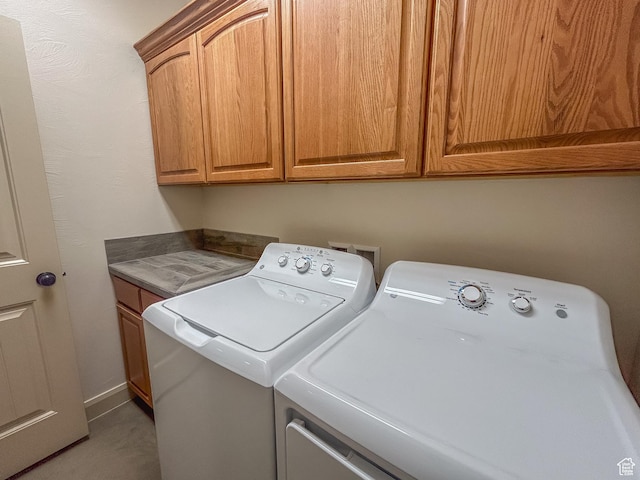 washroom featuring separate washer and dryer, carpet floors, and cabinet space