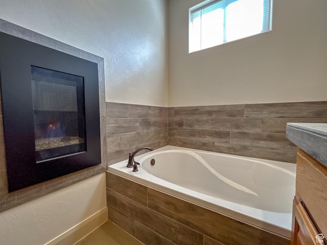 full bathroom with a garden tub and vanity