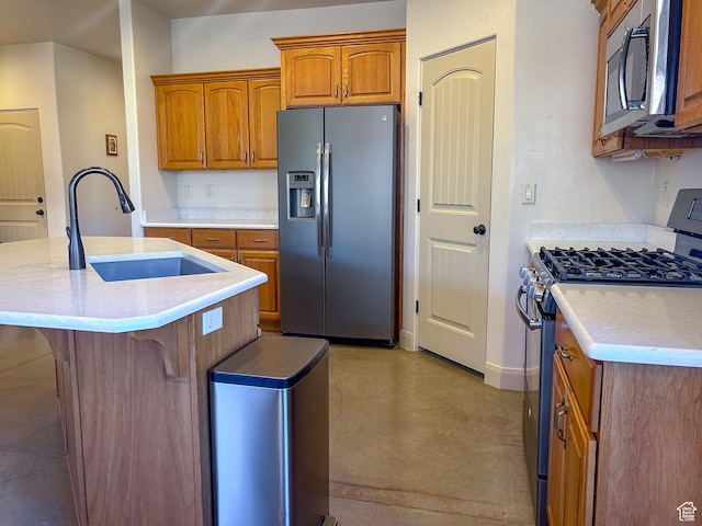kitchen featuring stainless steel appliances, a sink, baseboards, finished concrete floors, and brown cabinets