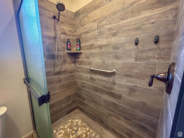 full bathroom with a shower stall and toilet