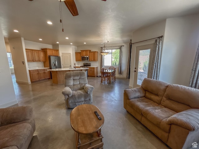 living room featuring ceiling fan, baseboards, finished concrete floors, and recessed lighting
