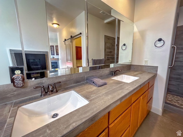 full bath featuring double vanity, visible vents, tile patterned flooring, and a sink