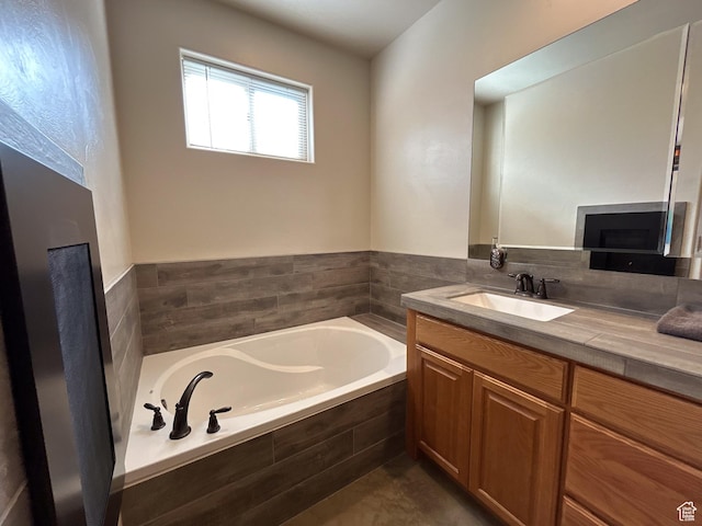 full bath with a fireplace, a bath, and vanity