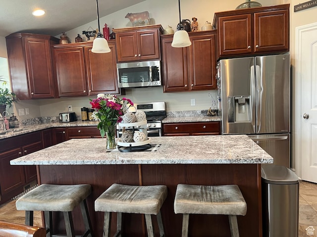 3158 S 2985 W, West Haven, UT 84401 - kitchen featuring appliances with stainless steel finishes, a breakfast bar area, a kitchen island, recessed lighting, and pendant lighting