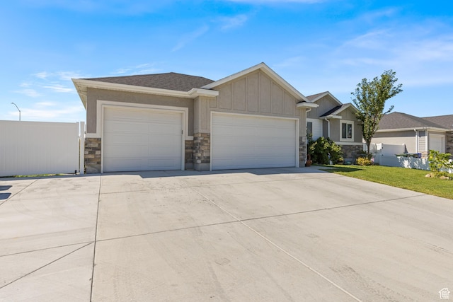 1317 N Providence Way, Tooele, UT 84074 - view of front facade featuring an attached garage, driveway, and stone siding
