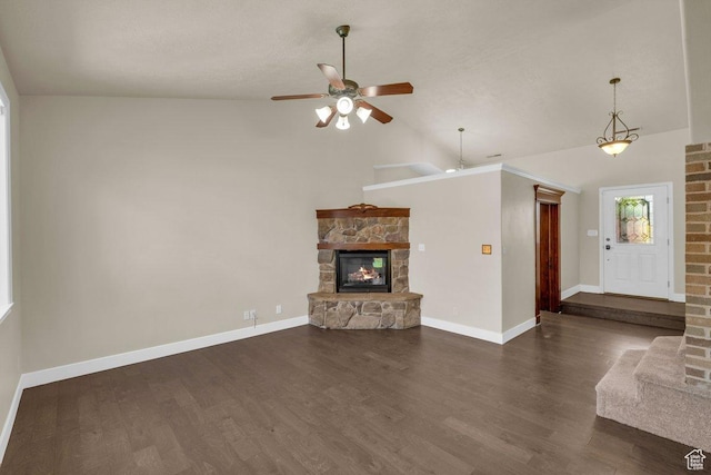 unfurnished living room with wood finished floors, a stone fireplace, baseboards, high vaulted ceiling, and ceiling fan