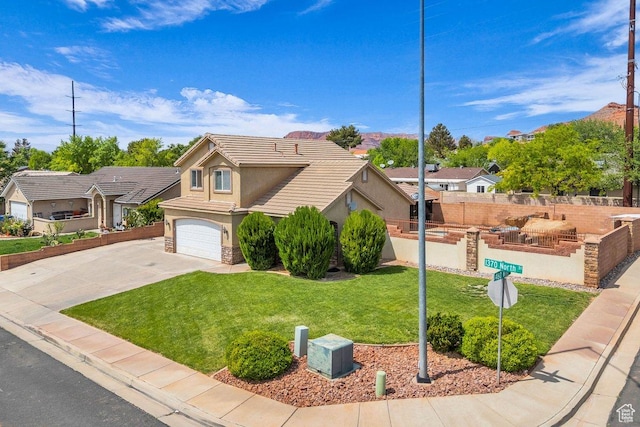 view of front of home with driveway, fence, an attached garage, a front yard, and stucco siding