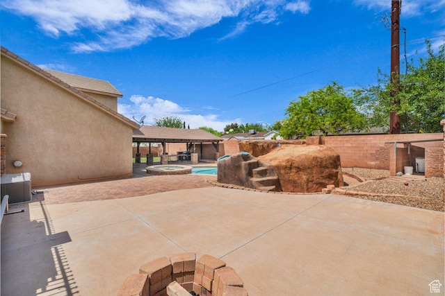 view of patio featuring a pool with connected hot tub