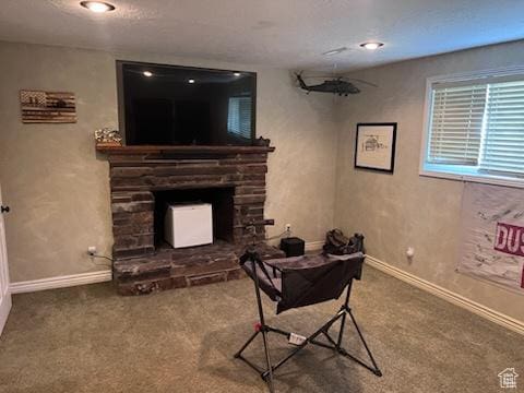 living room with a fireplace, baseboards, and carpet floors