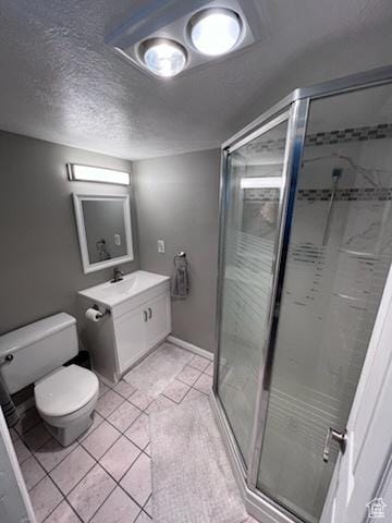 full bath featuring tile patterned floors, a textured ceiling, a stall shower, vanity, and toilet