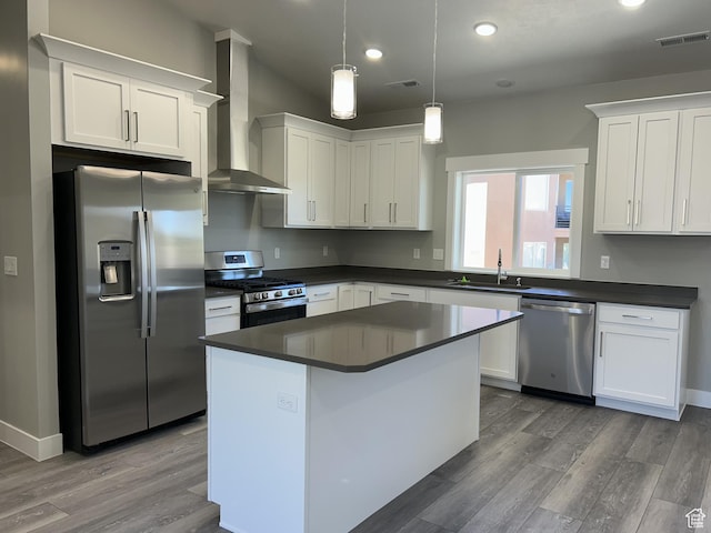 1152 E Smokey Trail Way, Cedar City, UT 84721 - kitchen with stainless steel appliances, wall chimney range hood, a sink, wood finished floors, and recessed lighting