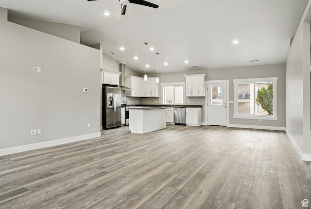 1152 E Smokey Trail Way, Cedar City, UT 84721 - unfurnished living room with a ceiling fan, baseboards, light wood-style floors, healthy amount of natural light, and recessed lighting