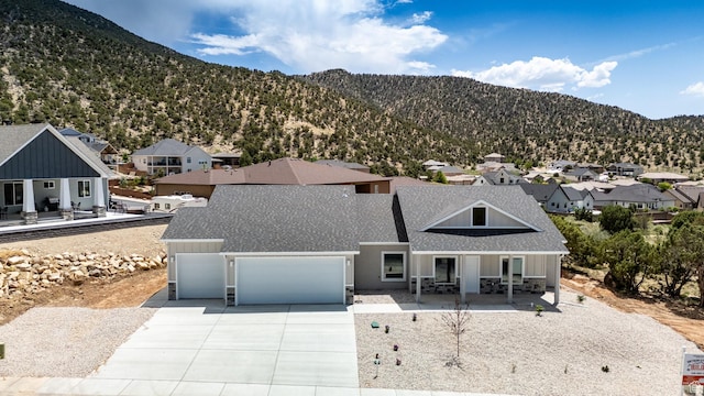 1152 E Smokey Trail Way, Cedar City, UT 84721 - view of front facade with covered porch, roof with shingles, an attached garage, a residential view, and concrete driveway