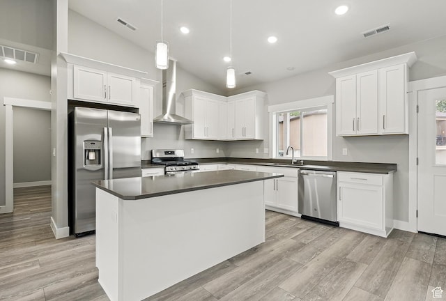 1152 E Smokey Trail Way, Cedar City, UT 84721 - kitchen featuring stainless steel appliances, wall chimney exhaust hood, a sink, dark countertops, and white cabinetry
