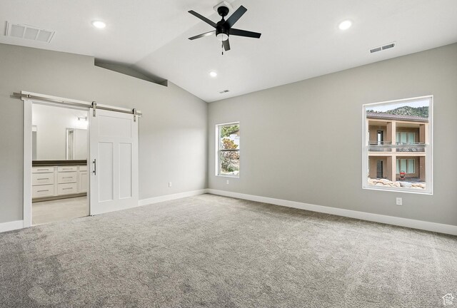 1152 E Smokey Trail Way, Cedar City, UT 84721 - empty room featuring a barn door, light carpet, a ceiling fan, baseboards, and lofted ceiling