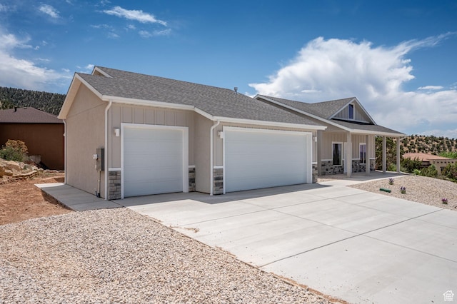 1152 E Smokey Trail Way, Cedar City, UT 84721 - view of front facade featuring a garage, stone siding, concrete driveway, a shingled roof, and covered porch