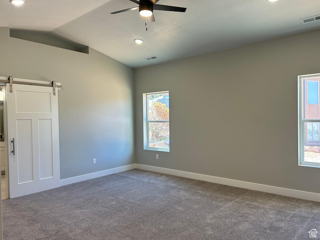 1152 E Smokey Trail Way, Cedar City, UT 84721 - empty room featuring ceiling fan, carpet floors, a barn door, baseboards, and lofted ceiling