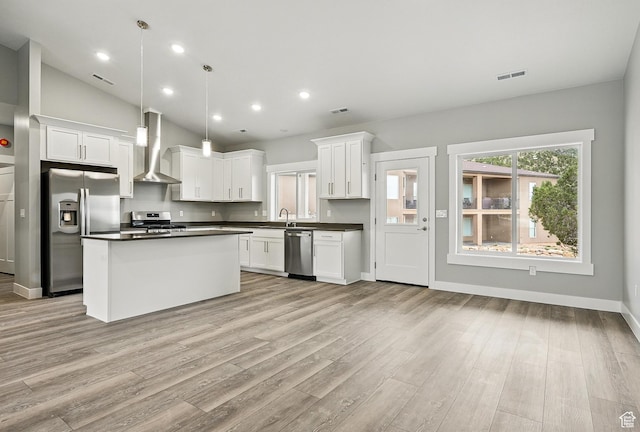 1152 E Smokey Trail Way, Cedar City, UT 84721 - kitchen featuring appliances with stainless steel finishes, wall chimney range hood, dark countertops, light wood-type flooring, and white cabinetry