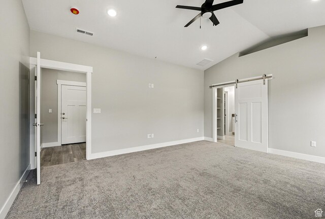1152 E Smokey Trail Way, Cedar City, UT 84721 - unfurnished bedroom with a barn door, carpet floors, lofted ceiling, baseboards, and ceiling fan