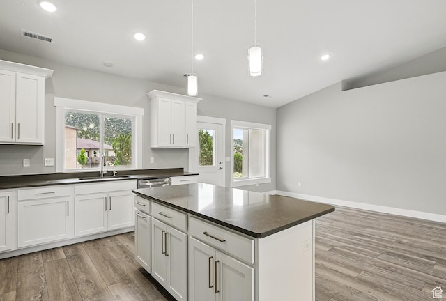 1152 E Smokey Trail Way, Cedar City, UT 84721 - kitchen featuring a sink, dark countertops, light wood finished floors, white cabinetry, and lofted ceiling