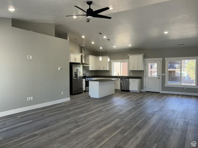 1152 E Smokey Trail Way, Cedar City, UT 84721 - kitchen featuring stainless steel appliances, open floor plan, dark countertops, baseboards, and a kitchen island