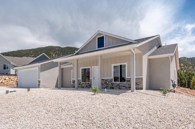 1152 E Smokey Trail Way, Cedar City, UT 84721 - view of front of home with a porch, board and batten siding, concrete driveway, stone siding, and a shingled roof