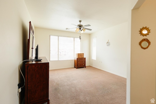 bedroom with light carpet, a ceiling fan, and baseboards