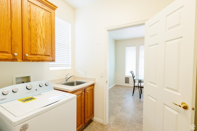 laundry area featuring washer / dryer, baseboards, cabinet space, and a sink