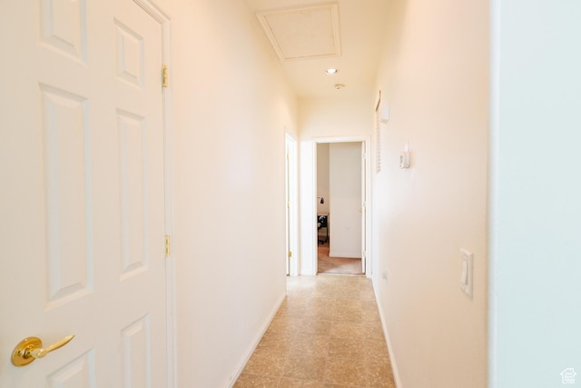 hallway with baseboards and recessed lighting