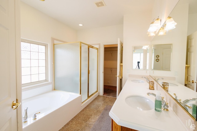 bathroom with a garden tub, a sink, visible vents, and a stall shower
