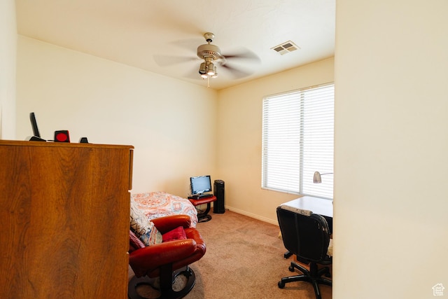 office area featuring baseboards, a ceiling fan, visible vents, and carpet