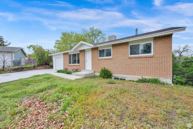 5148 W Redflower Cir, West Valley City, UT 84120 - ranch-style house with concrete driveway, brick siding, fence, and a garage