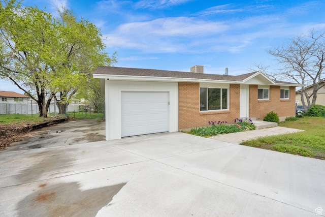 5148 W Redflower Cir, West Valley City, UT 84120 - single story home with brick siding, an attached garage, concrete driveway, and fence