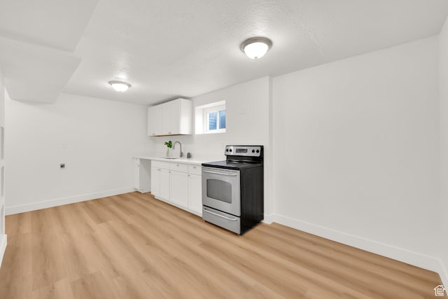 5148 W Redflower Cir, West Valley City, UT 84120 - kitchen with white cabinets, stainless steel electric stove, light wood-style flooring, and baseboards
