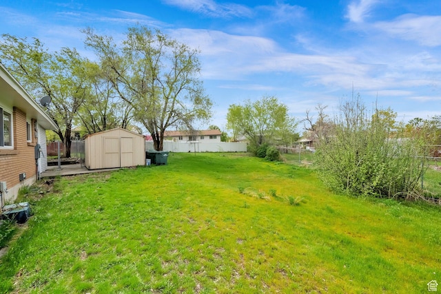 5148 W Redflower Cir, West Valley City, UT 84120 - view of yard with an outdoor structure, a shed, and a fenced backyard