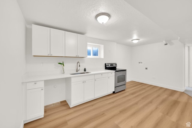 5148 W Redflower Cir, West Valley City, UT 84120 - kitchen with light countertops, stainless steel range with electric cooktop, light wood-type flooring, and a sink