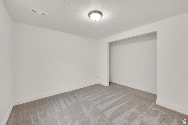 5148 W Redflower Cir, West Valley City, UT 84120 - carpeted empty room with baseboards, a textured ceiling, and visible vents