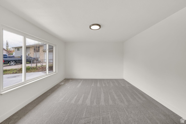 5148 W Redflower Cir, West Valley City, UT 84120 - spare room featuring baseboards and carpet