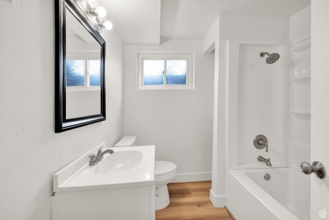 5148 W Redflower Cir, West Valley City, UT 84120 - bathroom with wood finished floors, toilet, vanity, baseboards, and  shower combination