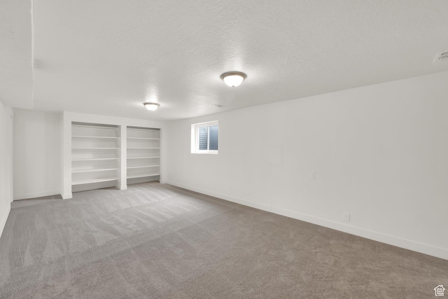 5148 W Redflower Cir, West Valley City, UT 84120 - basement with carpet floors, a textured ceiling, built in shelves, and baseboards