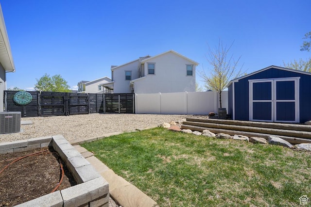 6961 W Goblin Valley Cv S, West Jordan, UT 84081 - view of yard featuring an outdoor structure, a storage unit, central AC, and a fenced backyard